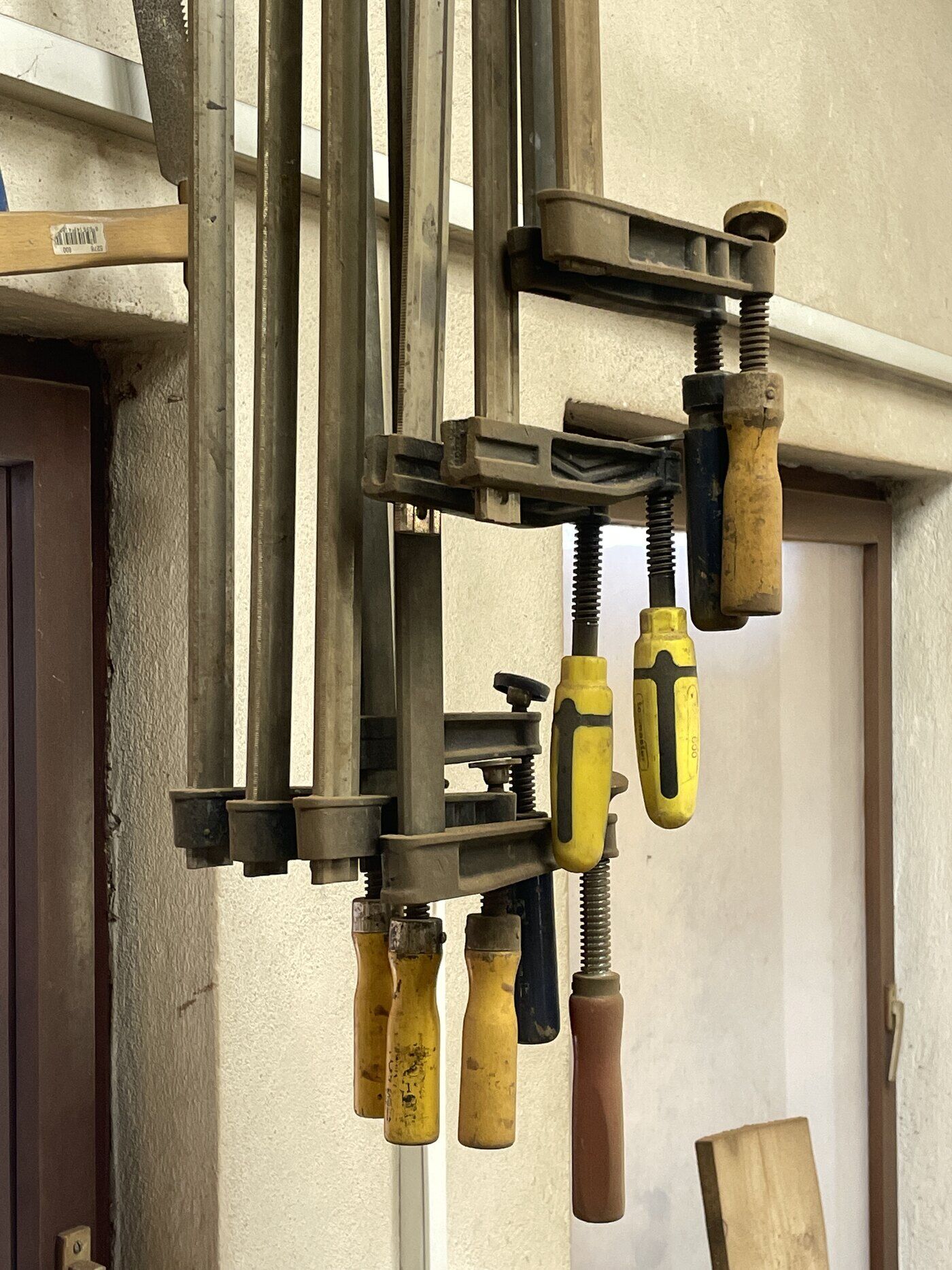 Bar clamps hanging in a carpentry workshop